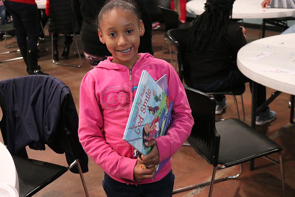 Little girl that got a book from a book party